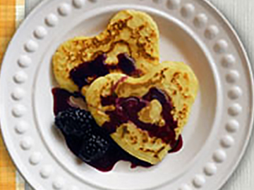 Heart-shaped pancakes with maple blackberry syrup